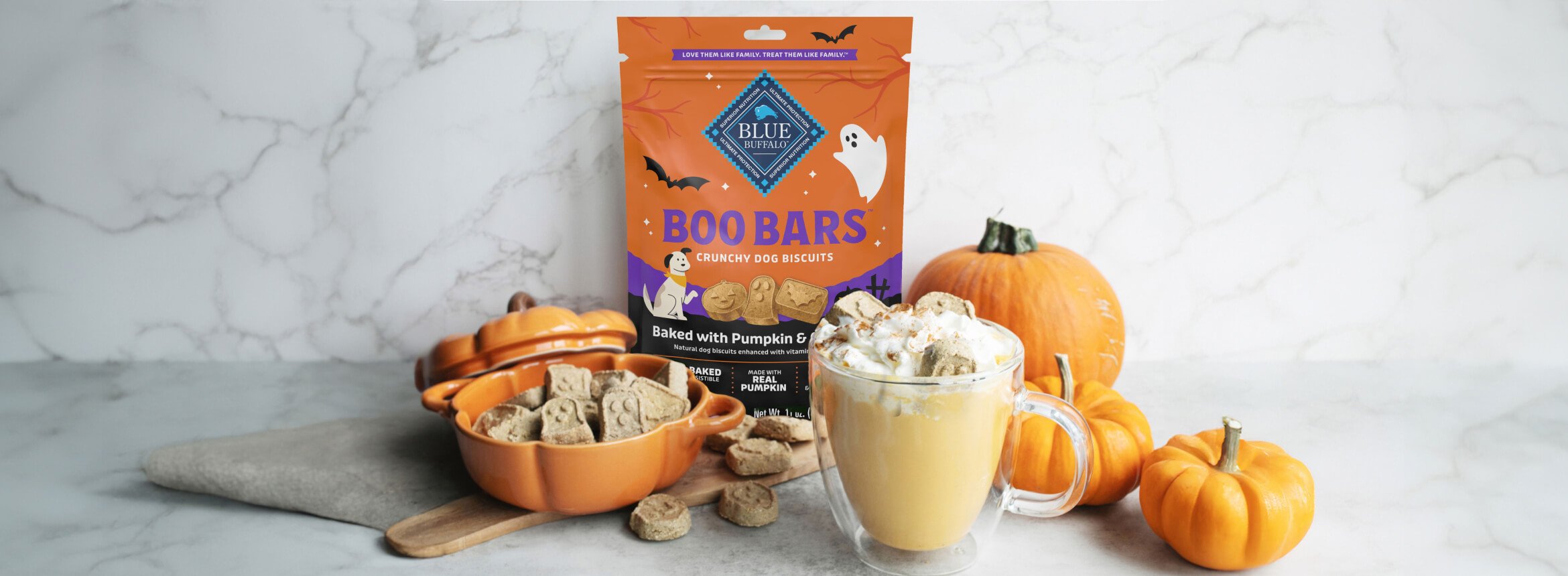 A bag of BLUE Boo Bars Pumpkin & Cinnamon Mini Biscuits pumpkin spice gummies next to a bowl of pumpkin spice ice cream, highlighting seasonal treats for fall.